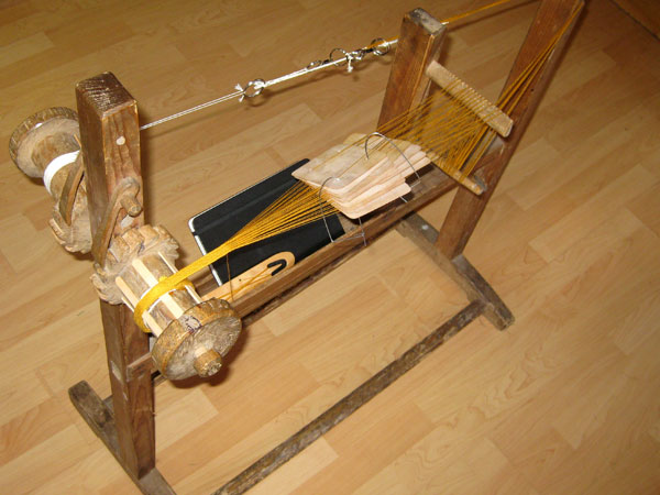 Ribbon loom with a tablet woven silk warp.